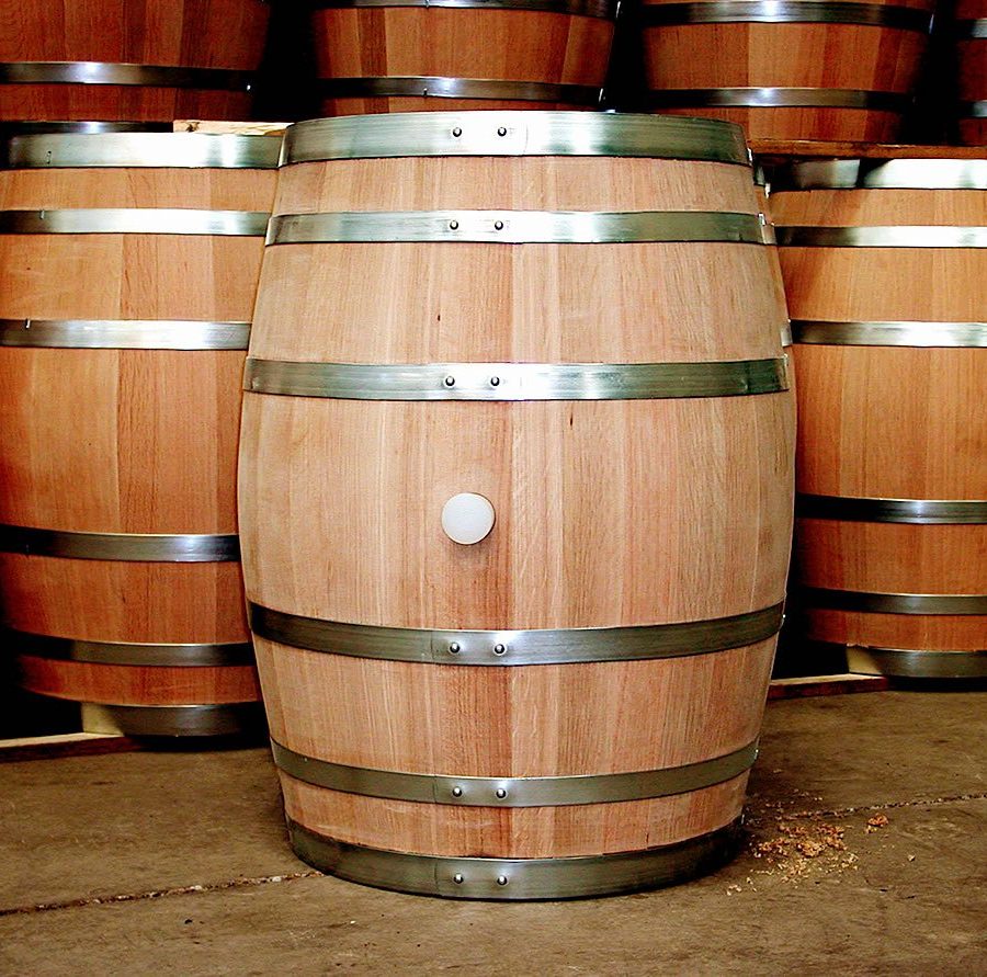 Pale unused oak barrels showing fresh wood grain in a cooperage