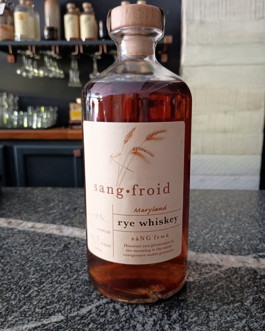 Sangfroid Maryland rye whiskey bottle on a bar counter