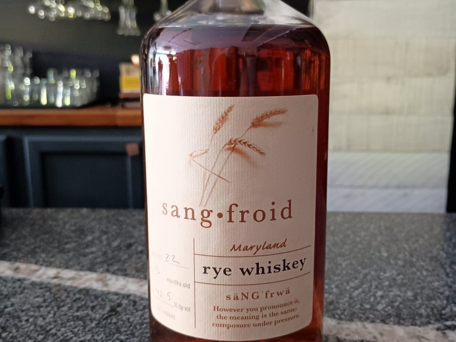Sangfroid Maryland rye whiskey bottle on a bar counter