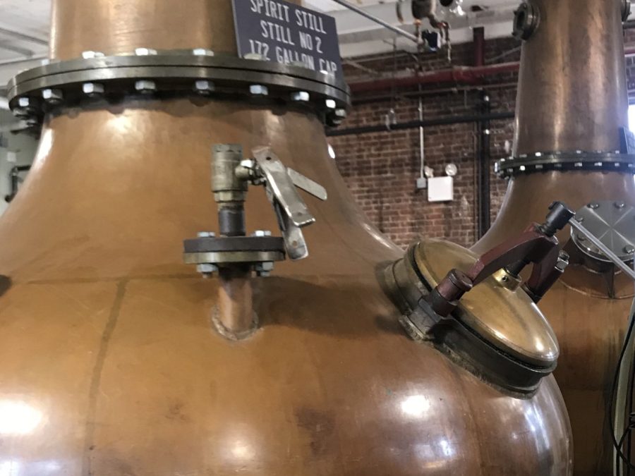 Close-up of a copper spirit still with a technical capacity placard